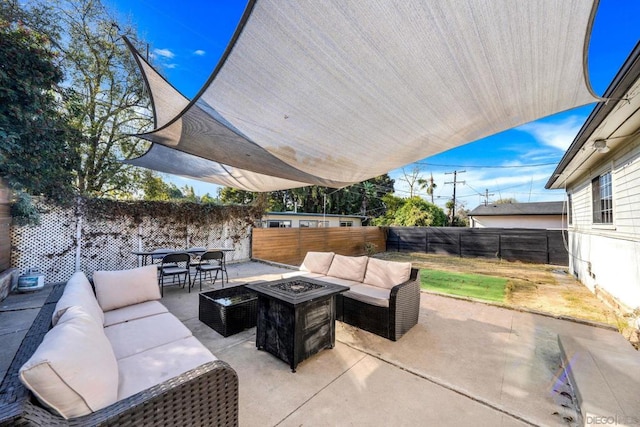 view of patio / terrace with an outdoor living space with a fire pit