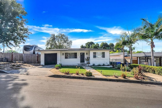 ranch-style home featuring a garage and a front yard