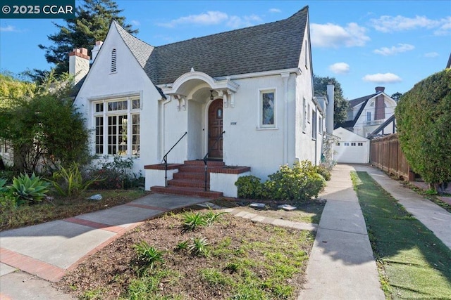 view of front of property with a garage and an outbuilding