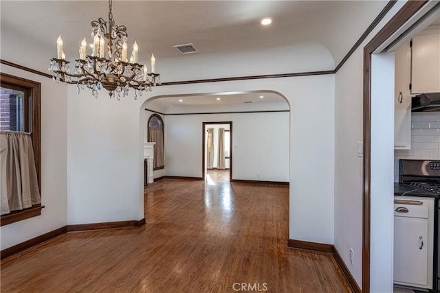 unfurnished dining area featuring crown molding and wood-type flooring