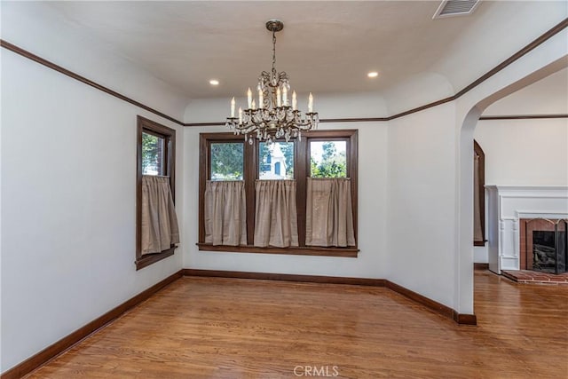 unfurnished dining area with hardwood / wood-style floors and a notable chandelier