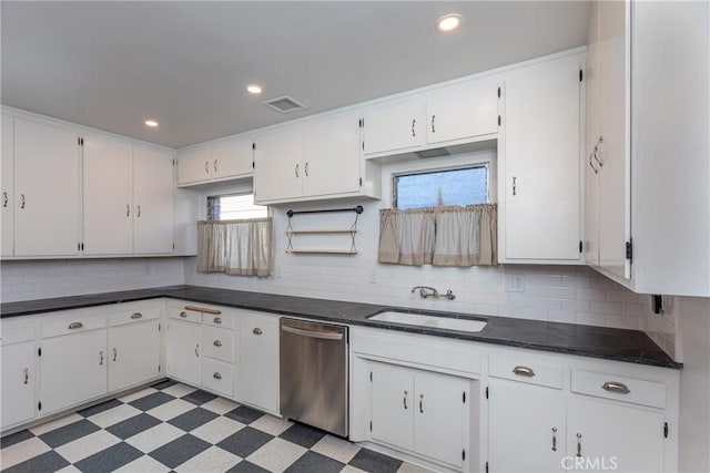 kitchen featuring white cabinetry, dishwasher, sink, and decorative backsplash