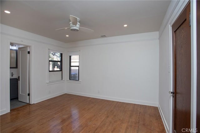 spare room featuring hardwood / wood-style floors and ceiling fan