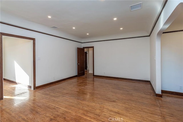 spare room with hardwood / wood-style floors