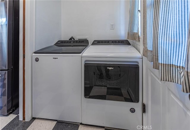 washroom featuring washer and clothes dryer