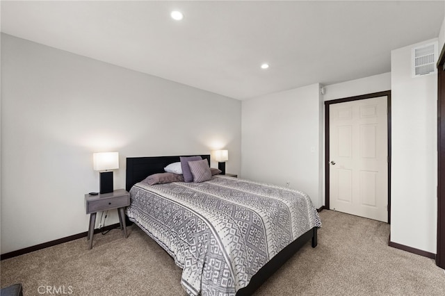 bedroom featuring visible vents, light colored carpet, and baseboards