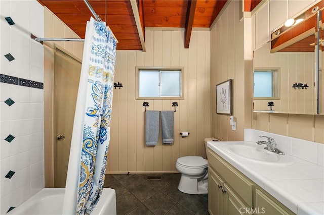 full bathroom with beamed ceiling, vanity, wood ceiling, toilet, and shower / bath combo with shower curtain