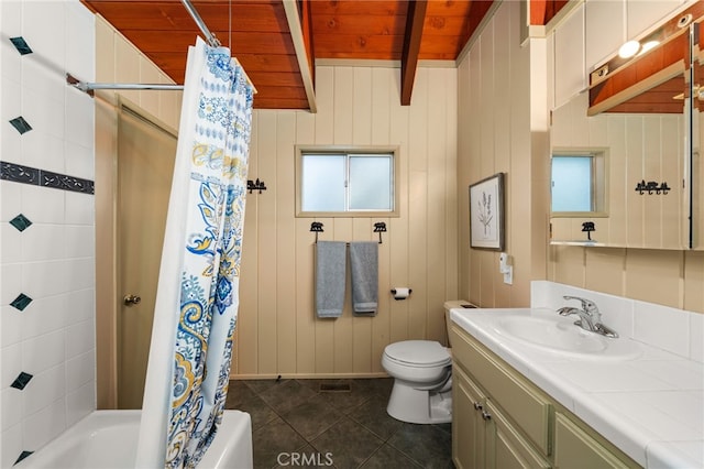 full bath with tile patterned flooring, beam ceiling, vanity, toilet, and shower / bathtub combination with curtain