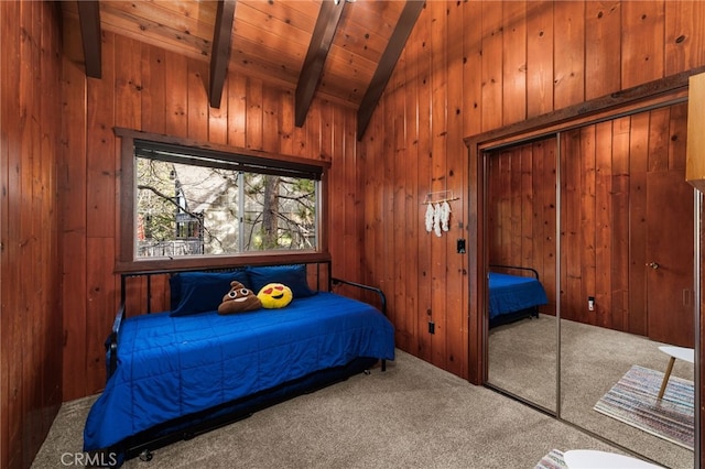 carpeted bedroom featuring high vaulted ceiling, wood walls, wooden ceiling, beamed ceiling, and a closet