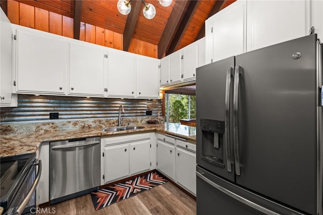 kitchen featuring lofted ceiling with beams, white cabinetry, sink, stainless steel appliances, and light stone countertops