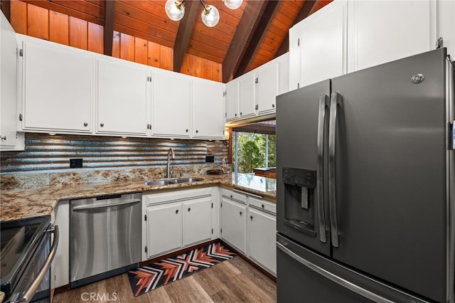 kitchen with dark wood-style flooring, appliances with stainless steel finishes, a sink, vaulted ceiling with beams, and wood ceiling
