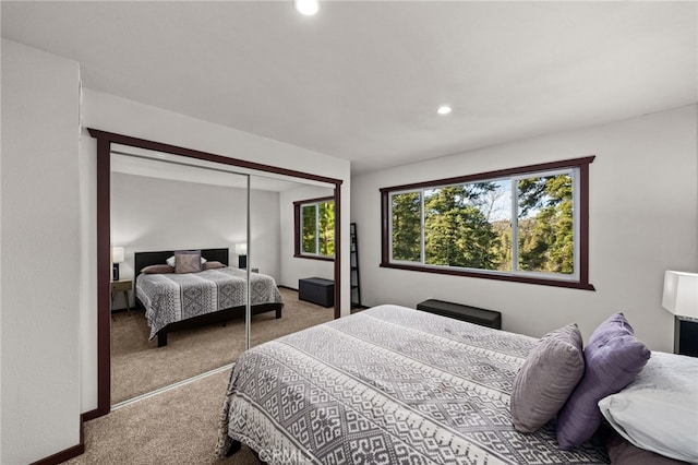 carpeted bedroom featuring recessed lighting and a closet