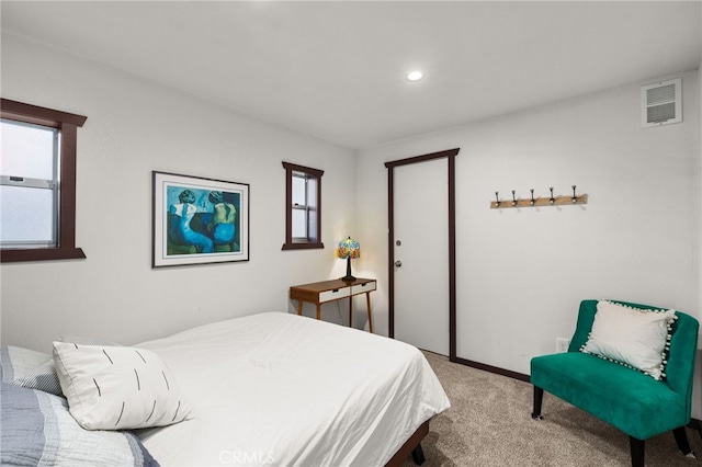 carpeted bedroom with recessed lighting, multiple windows, baseboards, and visible vents