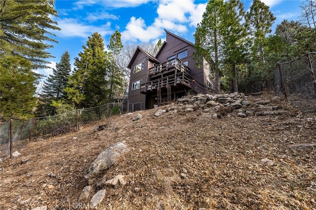 back of property with a wooden deck