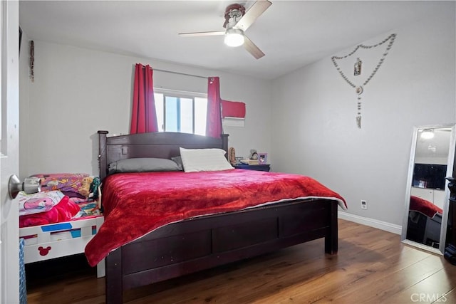 bedroom featuring hardwood / wood-style flooring and ceiling fan