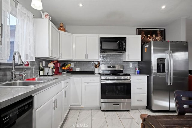 kitchen featuring tasteful backsplash, white cabinetry, sink, and black appliances