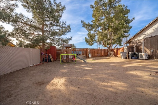 view of yard with a playground and ac unit