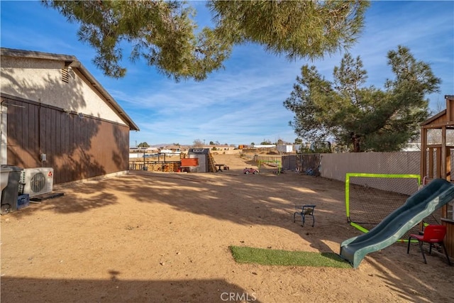 view of yard with a playground and ac unit