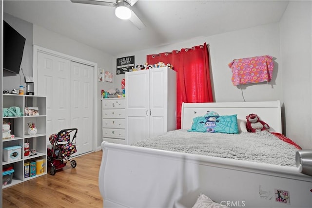 bedroom with hardwood / wood-style floors, a closet, and ceiling fan