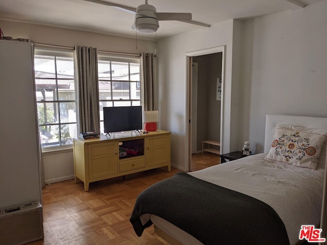 bedroom with ceiling fan and light parquet floors