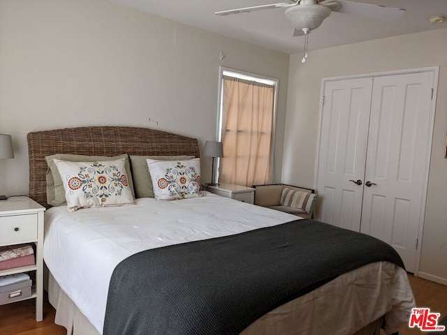 bedroom with hardwood / wood-style flooring, a closet, and ceiling fan