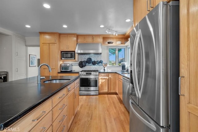 kitchen with appliances with stainless steel finishes, sink, light hardwood / wood-style flooring, and light brown cabinets