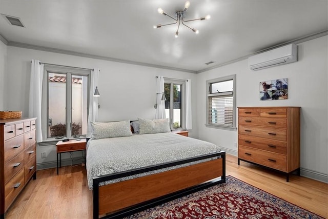 bedroom featuring ornamental molding, a wall mounted AC, an inviting chandelier, and light hardwood / wood-style flooring