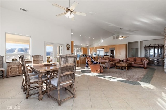 tiled dining room featuring french doors, ceiling fan, and high vaulted ceiling