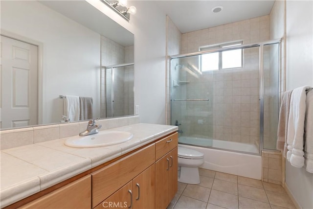 full bathroom with vanity, tile patterned floors, enclosed tub / shower combo, and toilet