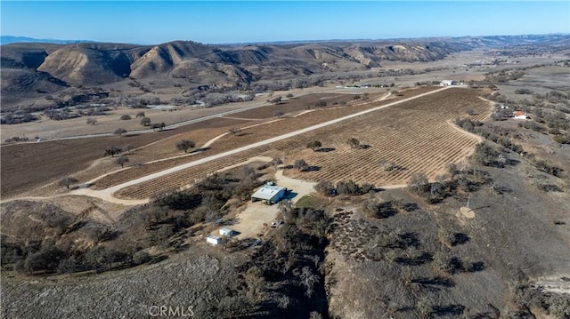 drone / aerial view featuring a mountain view and a rural view