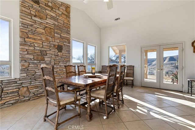 dining area featuring light tile patterned floors, high vaulted ceiling, french doors, and ceiling fan