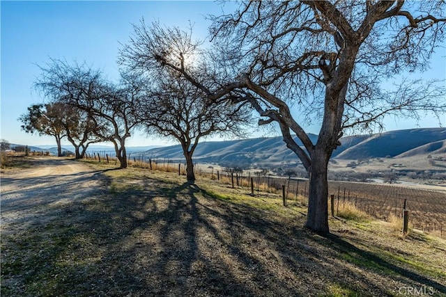 view of yard with a mountain view and a rural view