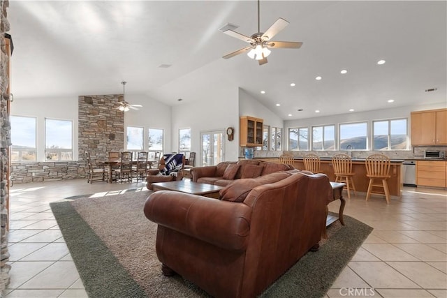 living room featuring light tile patterned floors, high vaulted ceiling, and ceiling fan