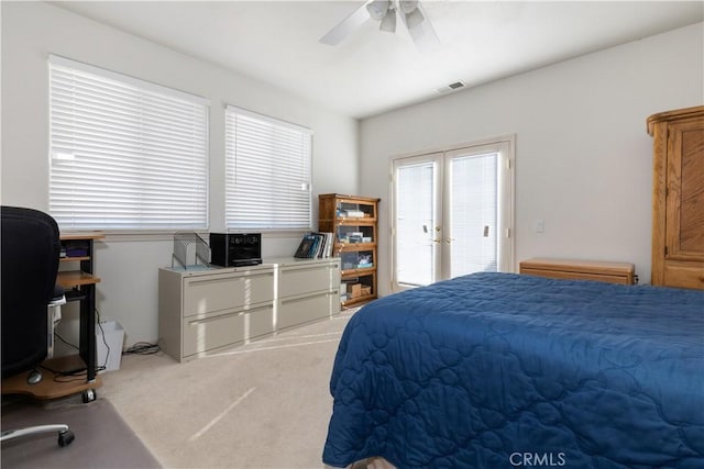 bedroom featuring light colored carpet, ceiling fan, and french doors