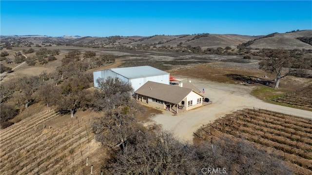 birds eye view of property with a mountain view and a rural view