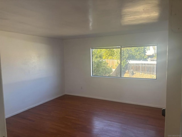 empty room with dark hardwood / wood-style floors