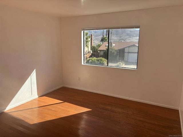 unfurnished room featuring dark hardwood / wood-style flooring