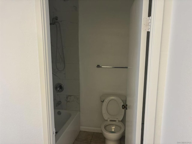 bathroom with toilet and tile patterned flooring