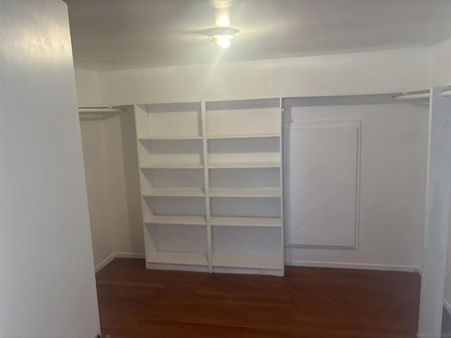 walk in closet featuring dark wood-type flooring