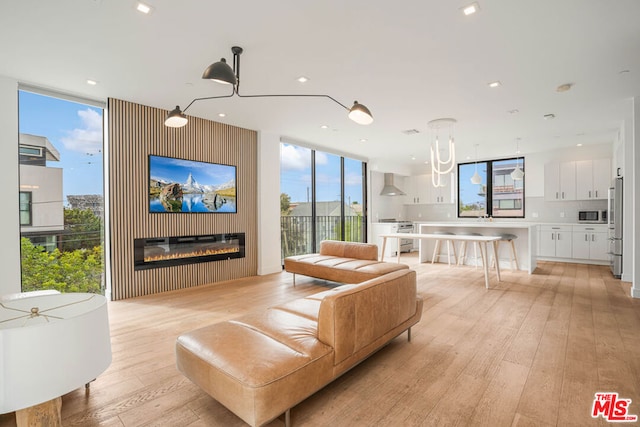 living room featuring light hardwood / wood-style flooring and a wall of windows