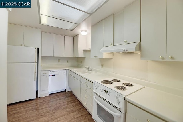 kitchen with sink, white cabinets, white appliances, and light wood-type flooring