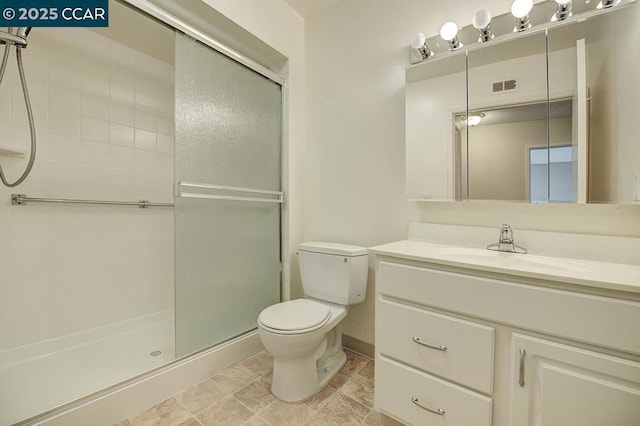 bathroom with vanity, an enclosed shower, and toilet