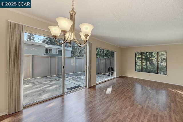 interior space with crown molding, a healthy amount of sunlight, and hardwood / wood-style floors