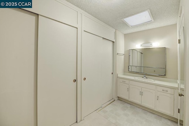 bathroom with vanity and a textured ceiling