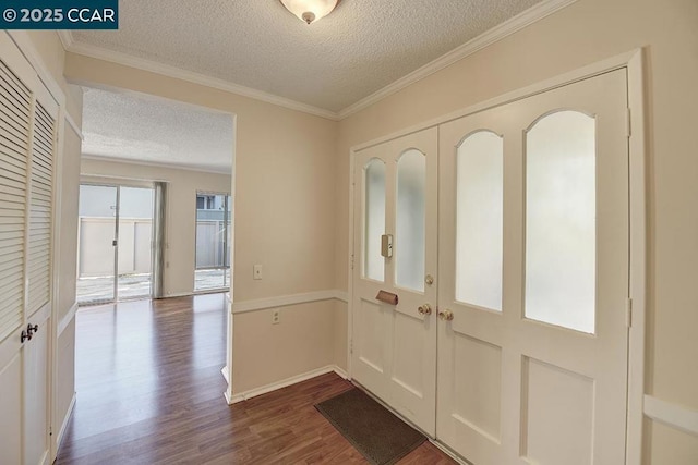 entrance foyer featuring wood-type flooring, crown molding, and a textured ceiling