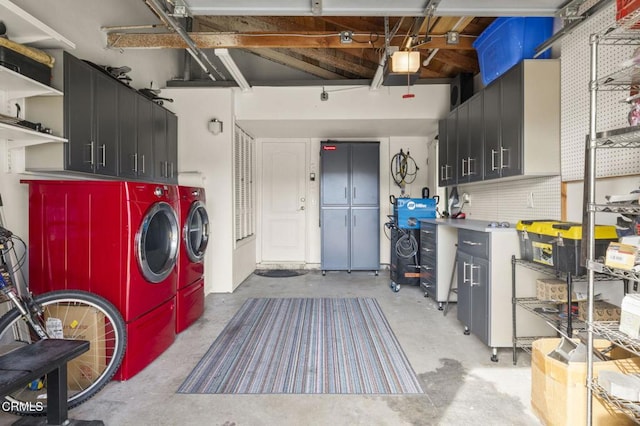 laundry room with a workshop area and independent washer and dryer