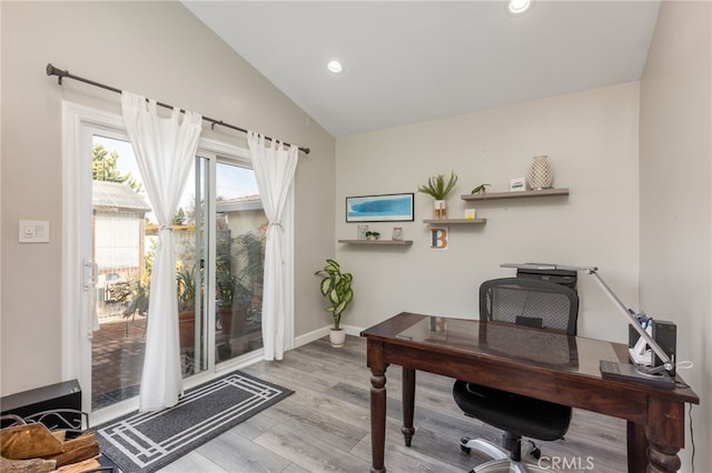 office area featuring light hardwood / wood-style floors and vaulted ceiling