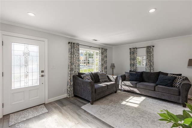 living room featuring ornamental molding and light hardwood / wood-style floors