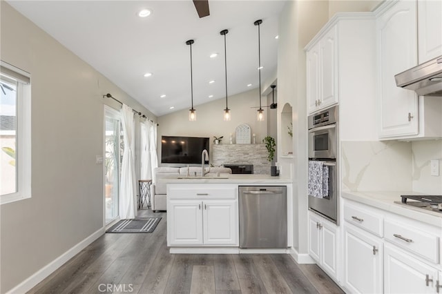 kitchen with sink, white cabinetry, appliances with stainless steel finishes, dark hardwood / wood-style flooring, and pendant lighting