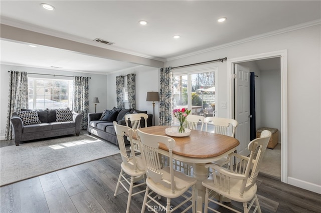 dining space with crown molding and dark hardwood / wood-style flooring